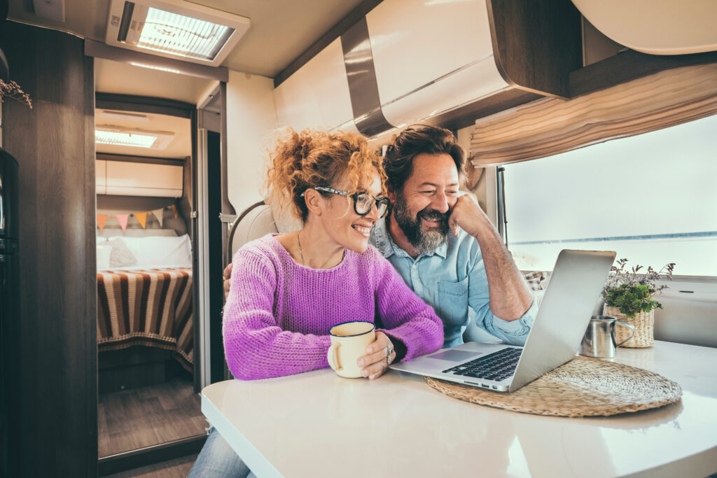 Man and woman using computer in RV